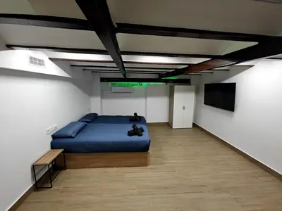 a bedroom with a blue bed and a flat screen tv at Gorgeous Appartment in Martorell-Barcelona in Martorell