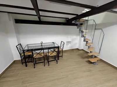 a dining room with a table and chairs and a staircase at Gorgeous Appartment in Martorell-Barcelona in Martorell