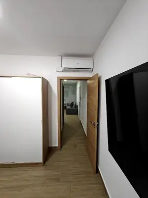 a room with a flat screen tv and a hallway at Gorgeous Appartment in Martorell-Barcelona in Martorell