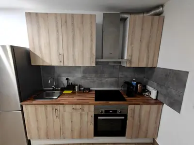 a kitchen with wooden cabinets and a sink at Gorgeous Appartment in Martorell-Barcelona in Martorell
