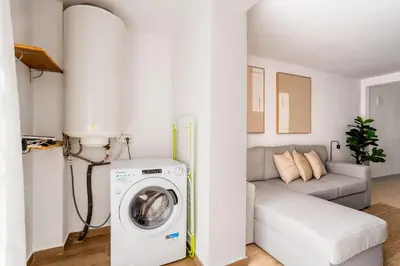 a bedroom with a bed with a blue accent wall at The Collection Barcelona - Eixample 4BD 2BTh with private Terrace in Barcelona