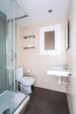 a bedroom with white walls and a bed with two towels at The Collection Barcelona - Eixample 4BD 2BTh with private Terrace in Barcelona