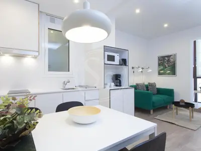 a living room with a large television and a table at Wonderful apartment for 6 in Barcelona