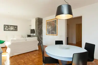 a dining room and living room with a table and chairs at Céntrico apartamento familiar in Barcelona