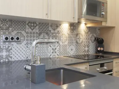 a kitchen with a stainless steel sink with a faucet at Nice apartment on Valencia Street in Barcelona