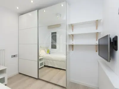 a room with a sliding glass door with a bed in it at Nice apartment on Valencia Street in Barcelona