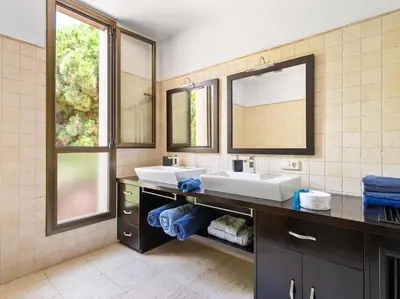 a bathroom with two sinks and a large mirror at Villa Llum with Views, Pool 25 minutes from BCN in Alella