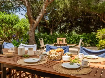 a wooden table with plates of food on it at Villa Llum with Views, Pool 25 minutes from BCN in Alella