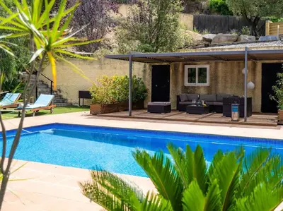 a villa with a swimming pool and a house at Villa Llum with Views, Pool 25 minutes from BCN in Alella