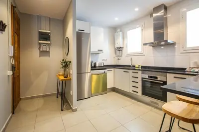 a kitchen with white cabinets and a counter top at 21MAL1089-Magnific apartment near Sagrada familia in Barcelona