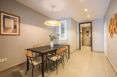 a dining room with a black table and chairs at 21MAL1089-Magnific apartment near Sagrada familia in Barcelona