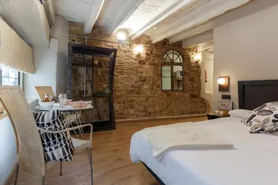 a room with a bed and a table in it at AinB Picasso-Corders Apartments in Barcelona
