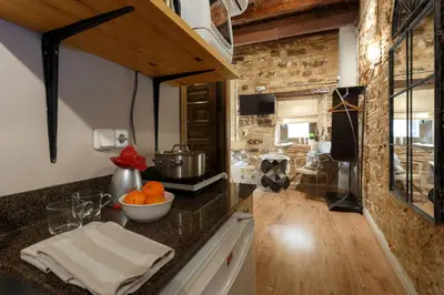 a kitchen with a counter top with a sink at AinB Picasso-Corders Apartments in Barcelona