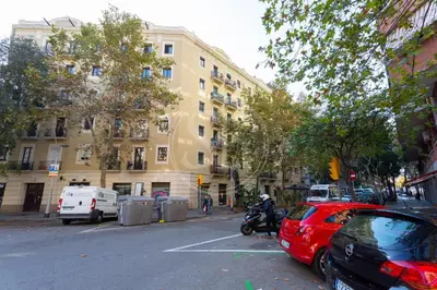 a red car parked in a parking lot next to a building at Bonito apartamento en l'Eixample in Barcelona