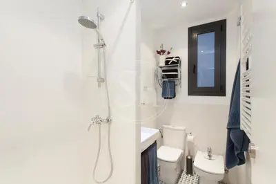 a bathroom with a toilet and a sink at Modern Eixample Apartment in Barcelona