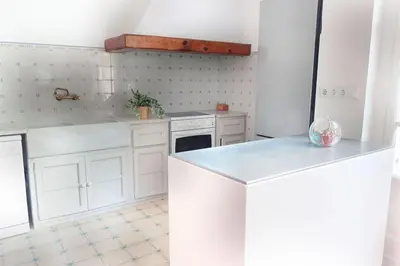 an empty room with a door and a red brick floor at Charming house in Sant Pol facing the sea in San Pol de Mar