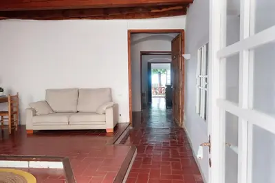 a living room with a couch and a hallway at Charming house in Sant Pol facing the sea in San Pol de Mar
