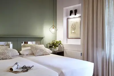 a bedroom with two white beds and a window at AinB Gothic-Jaume I Apartments in Barcelona