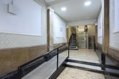 a hallway of a building with stairs and a window at Luminescent Valencia Apartment in Barcelona