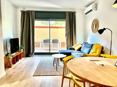 a living room with a blue couch and a table at Apartamento entero con patio en Terrassa, Barcelona in Terrassa