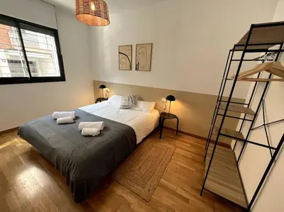 a bedroom with a bed with two pillows on it at Apartamento entero con patio en Terrassa, Barcelona in Terrassa