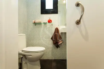 a bathroom with a sink and a red shower curtain at Apartamento para 3 in Barcelona