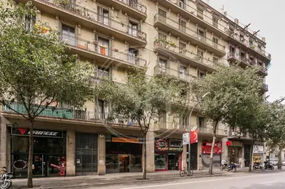 a building on a street with trees in front of it at Bonito apartamento en el Eixample in Barcelona