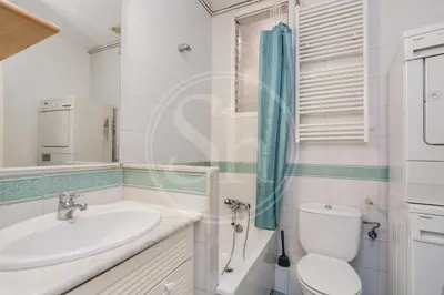 a kitchen with a refrigerator and a washing machine at Bonito apartamento en el Eixample in Barcelona