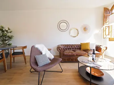 a living room with a leather couch and a table at BarcelonaForRent The Central Place in Barcelona