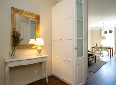a room with a mirror and a table with a lamp at BarcelonaForRent The Central Place in Barcelona