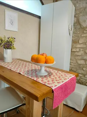 a table with a bowl of fruit on it at La Julita in San Quírico Safaja