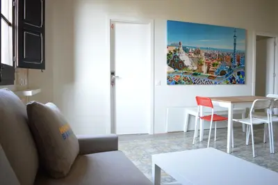 a living room with a couch and a table at Barcelona Classic Plaza Real Apartments in Barcelona