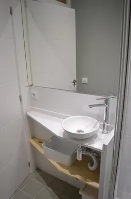 a white bathroom with a sink and a mirror at Barcelona Classic Plaza Real Apartments in Barcelona