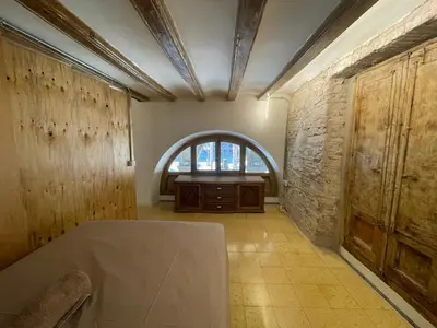 a room with an arch window and a table in it at Barcelona Classic Plaza Real Apartments in Barcelona
