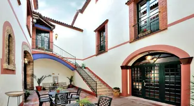 a patio with a table and chairs in a building at Hotel Can Carol in Capellades
