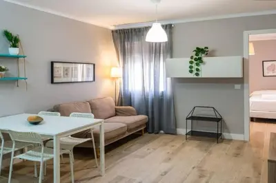 a living room with a couch and a table at BeBarceloner Vall Hebron Apartment in Barcelona