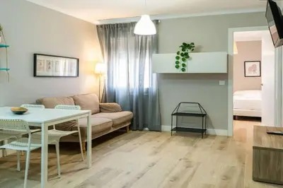 a living room with a couch and a table at BeBarceloner Vall Hebron Apartment in Barcelona