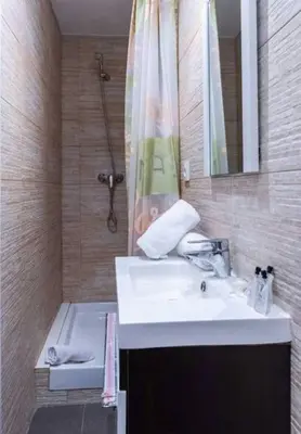 a bathroom with a sink and a shower and a tub at BeBarceloner Vall Hebron Apartment in Barcelona