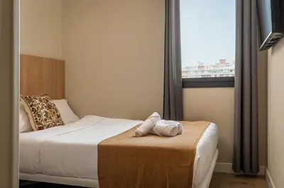 a hotel room with a bed and a window at Aerohotel Barcelona Airport 24h in El Prat de Llobregat