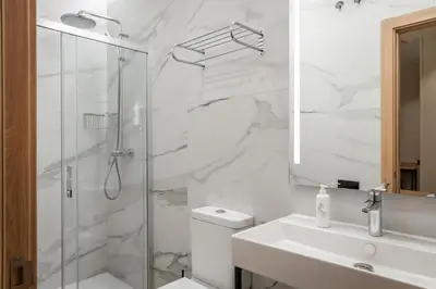 a bathroom with a shower and a toilet and a sink at Aerohotel Barcelona Airport 24h in El Prat de Llobregat