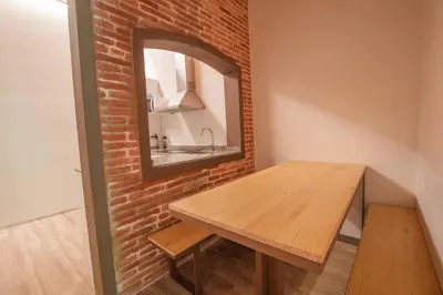 a bathroom with a wooden table and a mirror at Barcelona Classic Catedral Apartments in Barcelona