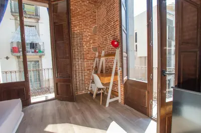 a room with a brick wall and a ladder at Barcelona Classic Catedral Apartments in Barcelona