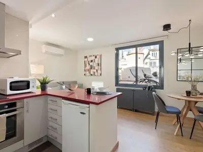 a white dining room with a white table and chairs at Penthouse in Barcelona with Large Terrace in Barcelona