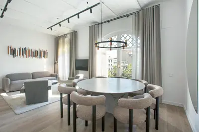 a dining room with a table and chairs at The Diagonal Suites by Sweett in Barcelona