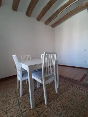 a white table and two chairs in a room at Canonge Rodó Apartments in Barcelona