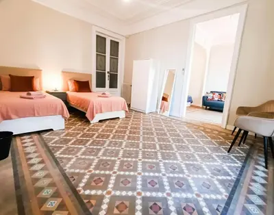 a bedroom with two beds and a carpet at Centric Rooms Ghotic in Barcelona