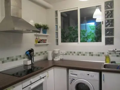 a kitchen with a sink and a washing machine at Apartment Barca 1 Camp Nou in Hospitalet de Llobregat