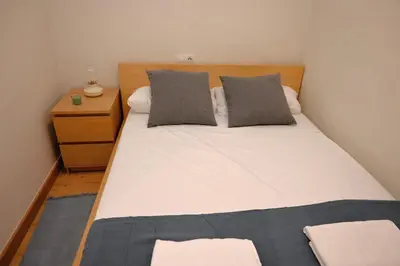 a bedroom with a large bed with two pillows at Homenfun Barcelona Alfonso X in Barcelona