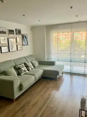a living room with a couch and a large window at Apartamento Ideal en Poblenou in Barcelona