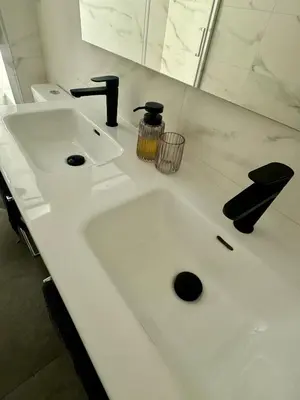 a white bathroom sink with a black faucet at Apartamento Ideal en Poblenou in Barcelona